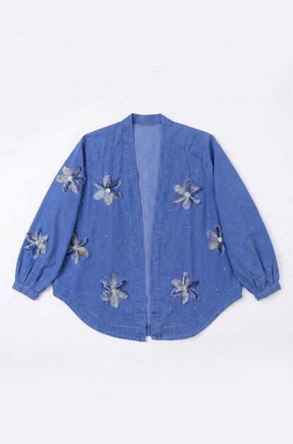Blue denim jacket with floral embellishments on a white background